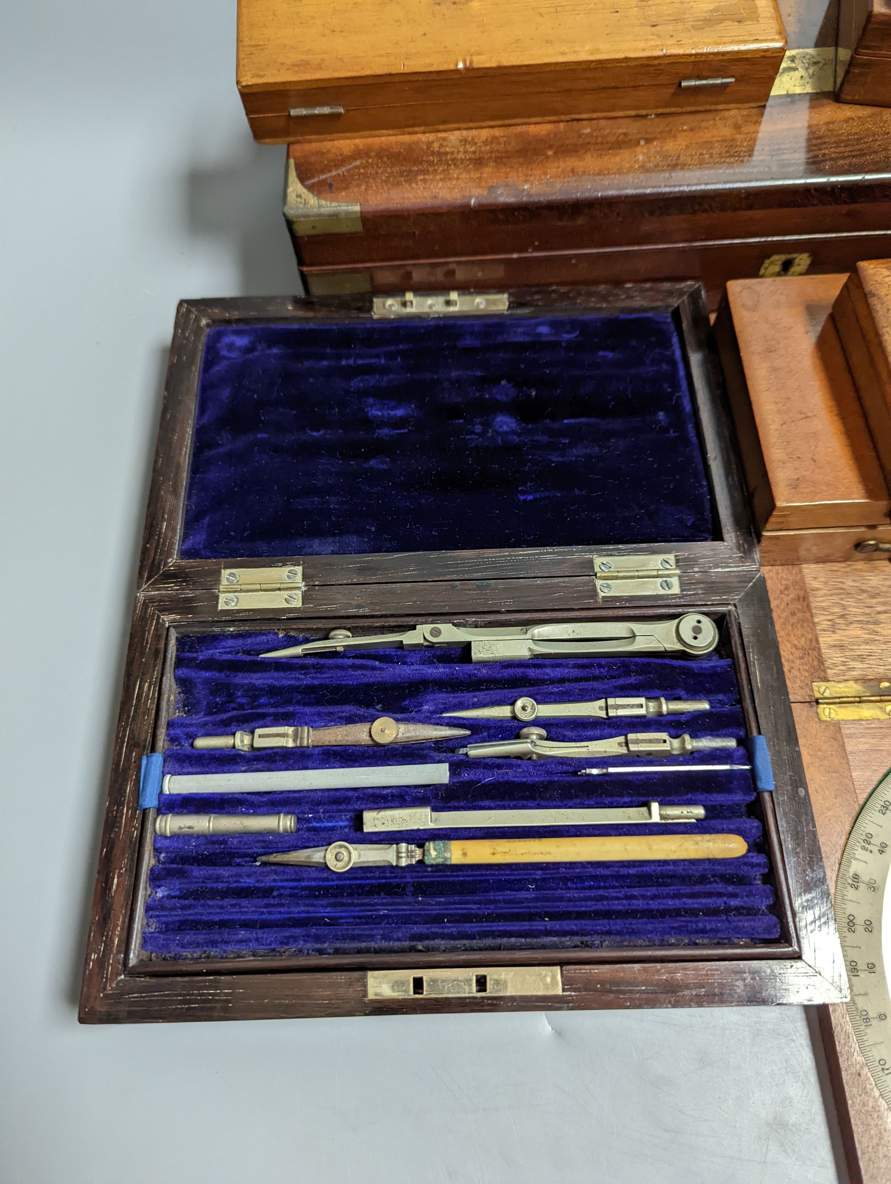 A collection of mahogany cased drawing instruments (8)